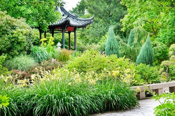 Asian garden park in summer with a beautiful gazebo and flower beds