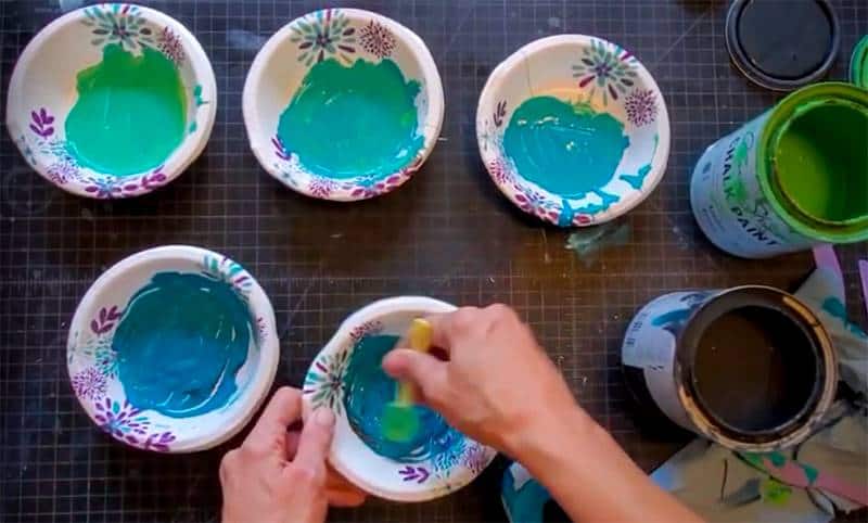 5 paper bowls with green-blue paint from light to dark with hand mixing