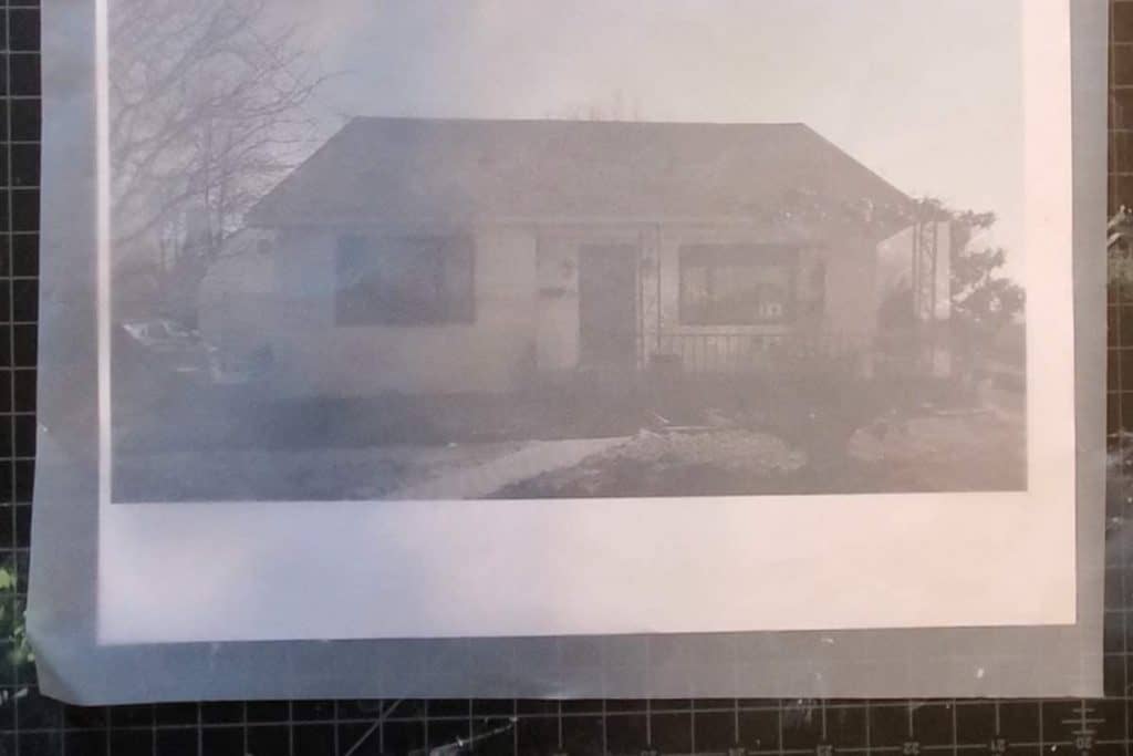 Printed photo of house with tracing paper over top