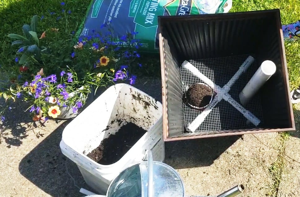 False bottom assembly with hardware cloth and PVC pipe stand.