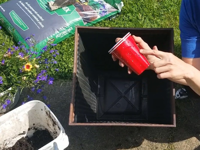 Poke lots of holes in the solo cups for water