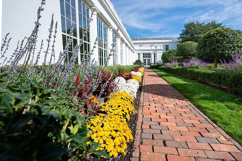 photo of brick walkway and flower border at white house garden